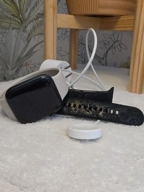 Apple smartwatch with white Wireless charger With Additional Black Floral Bands