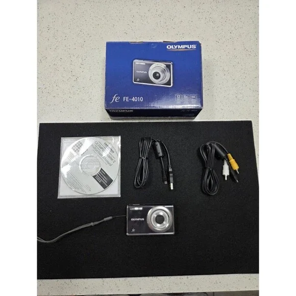 Olympus FE-4010 digital camera box featuring a 12-megapixel sensor and 4x Zoom