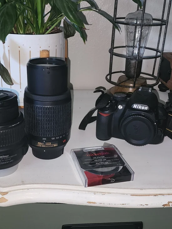 Nikon black DSLR Camera Body with Two Black Zoom Lenses