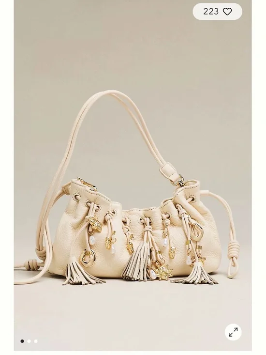 Dolce Vita Cream Tassel Drawstring Crossbody Bag with Gold Charms
