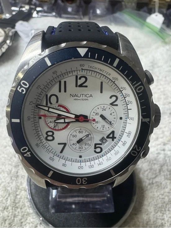 Nautica Silver Case White Dial Watch with Blue Bezel and Red Accents