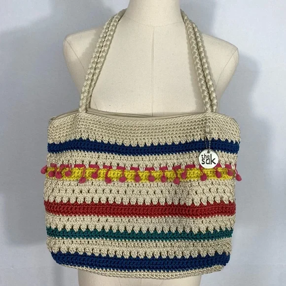 The Sak crocheted striped shoulder bag with pink pom-poms Casual Classics