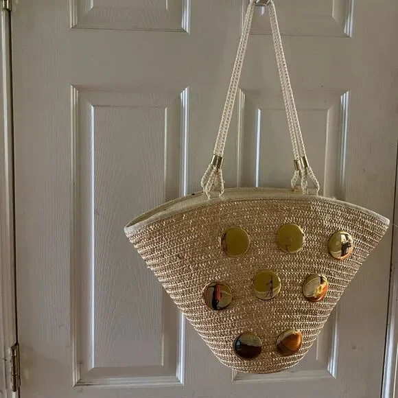 Natural straw bucket style tote bag with rope straps with gold tone acce…