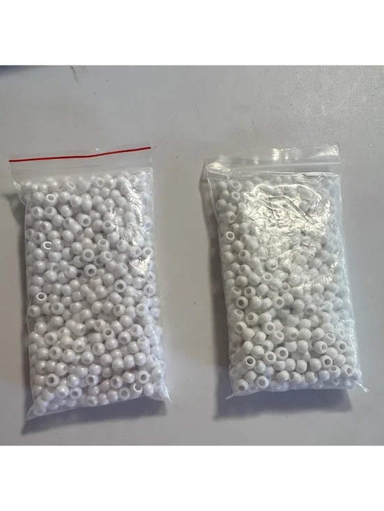 Two bags of white beads