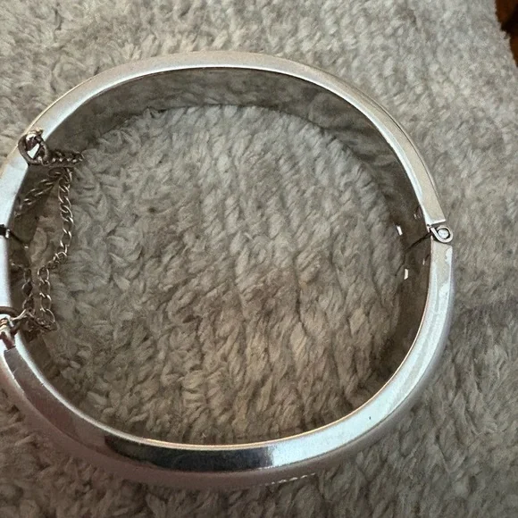 GUC silver tone bangle with safety chain