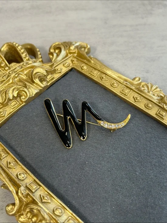 Vintage Trifari Black Enamel and Gold Crescent Brooch with Crystal Accent