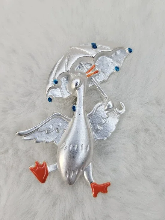 Playful Silver Goose Brooch with Orange Details