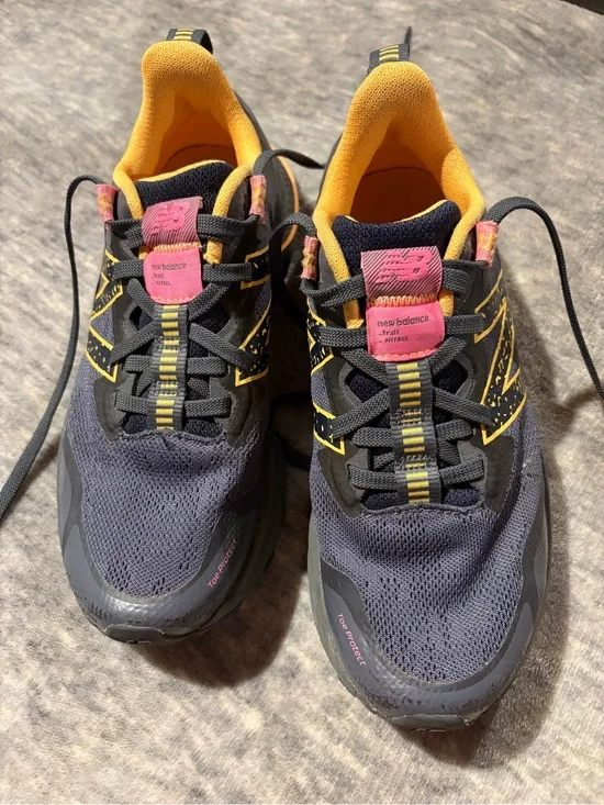 New Balance navy athletic sneakers with yellow and pink accents