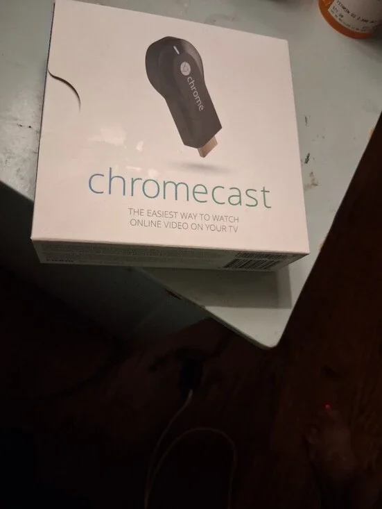 google Chromecast white box with black device image