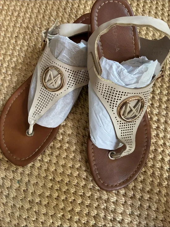 Nautica Cream Perforated Thong Sandals with Gold Emblem with 1.25 inch heel.