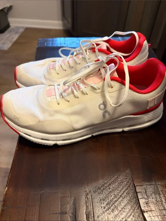 On Running White Athletic Shoes with Pink and Red Accents