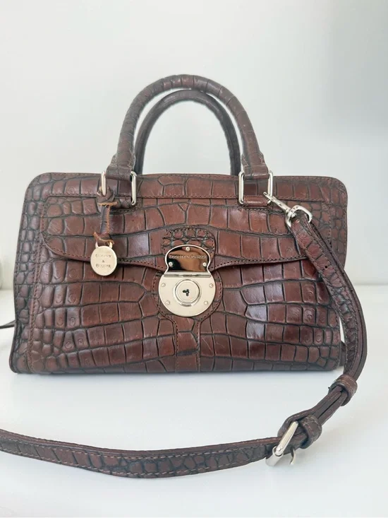 Dooney & Bourke, crafted from rich brown crocodile-embossed leather