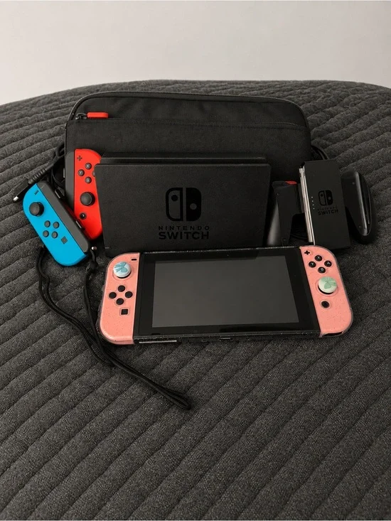 Nintendo Switch with Pink Joy‑Con Covers and Neon Blue/Red Controllers