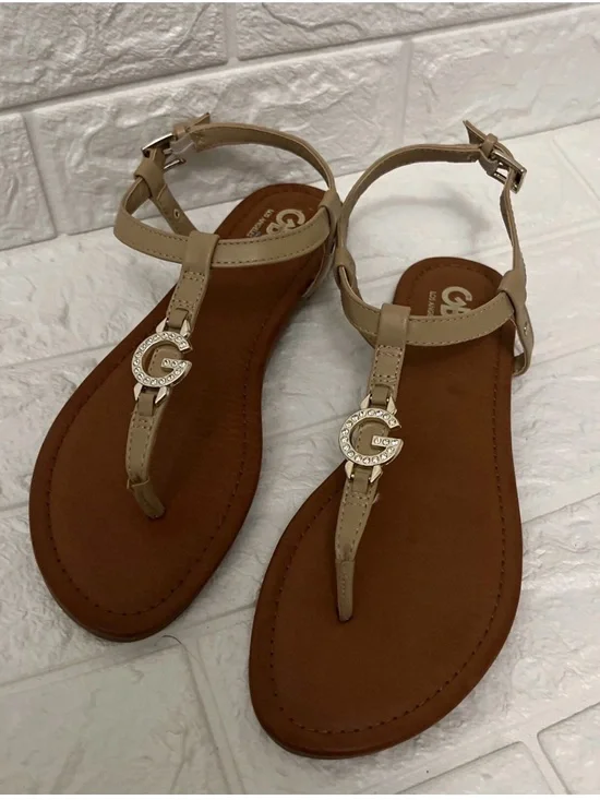 G by Guess Nude T-Strap Sandals with Gold Logo Accent