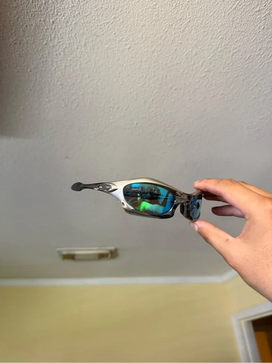 Oakley Silver Frame Sunglasses with Blue-Green Mirrored Lenses