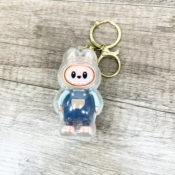 Labubu Monster Art Toy Keychain Blue Overalls Clear Protective Case Gold Tone