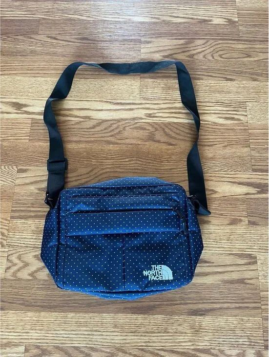 The North Face navy blue polka dot messenger bag