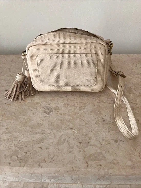 Anthropologie Cream Perforated Crossbody Camera Bag with Tassel