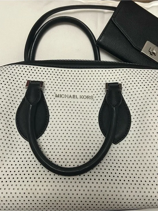 Michael Kors White Perforated Satchel with Black Trim and matching black wallet.
