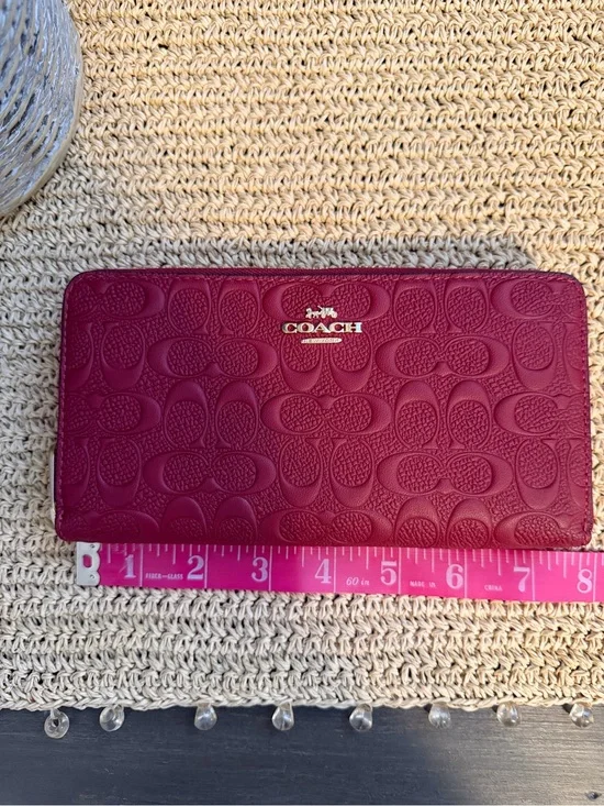 Coach Signature Embossed Continental Wallet in Berry