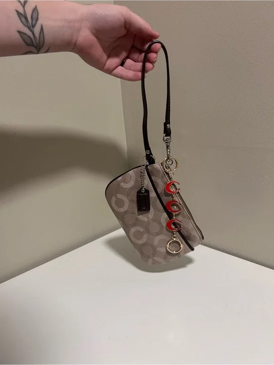 Coach Taupe Signature Canvas Wristlet with Red Charm Accents