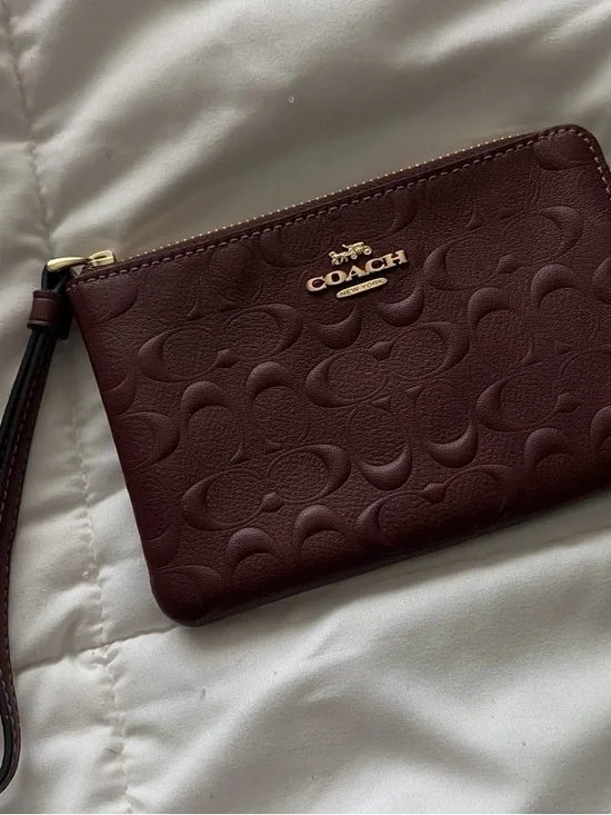 COACH Embossed Signature Wristlet in burgundy with Gold Logo, used once