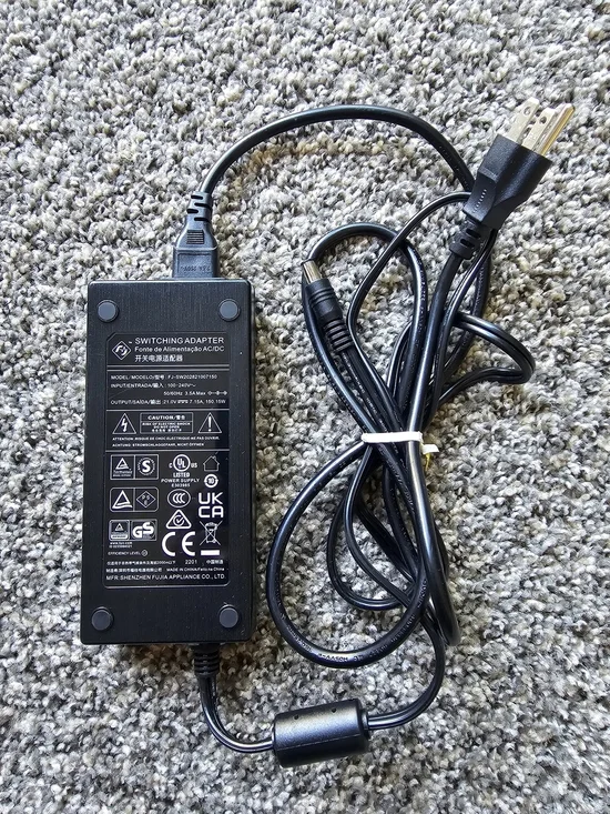 Shenzhen FJ-SW202821007150 switching power adapter.  Input: 100-240V~ 50/60Hz 3