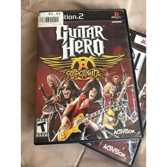 Set Up Two Guitar Hero Games.‎ Guitar Her II And Aerosmith. With Books 2667