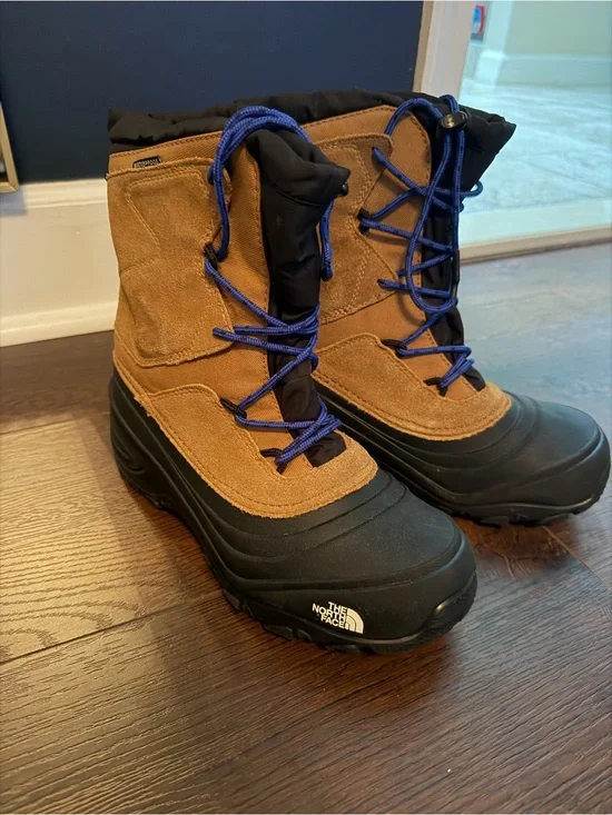 The North Face Kids Brown and Black Waterproof Snow Boots with Blue Laces