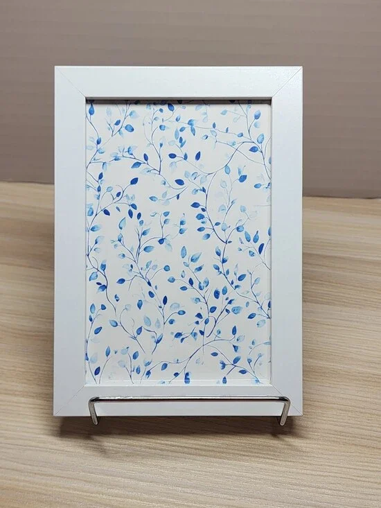 White Frame Wall Art with Blue Leaf Pattern