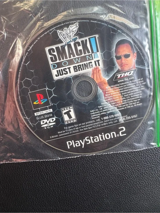 PlayStation 2 video game disc titled 'WWF SmackDown! Just Bring It'