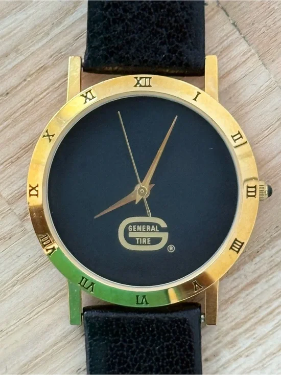 General Tire Dress Watch Black Dial Leather Strap Gold-Tone Case Hands