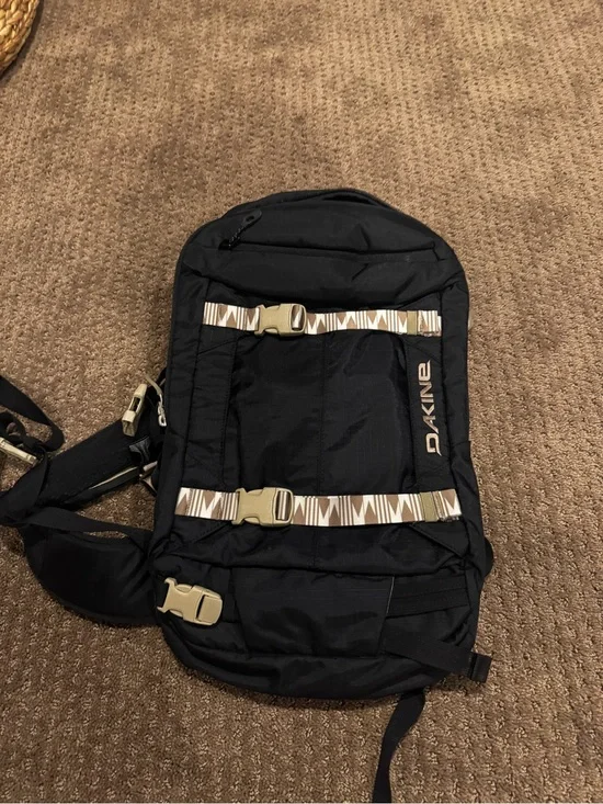 Dakine Black hydration Backpack with Tan Patterned Straps and hip straps