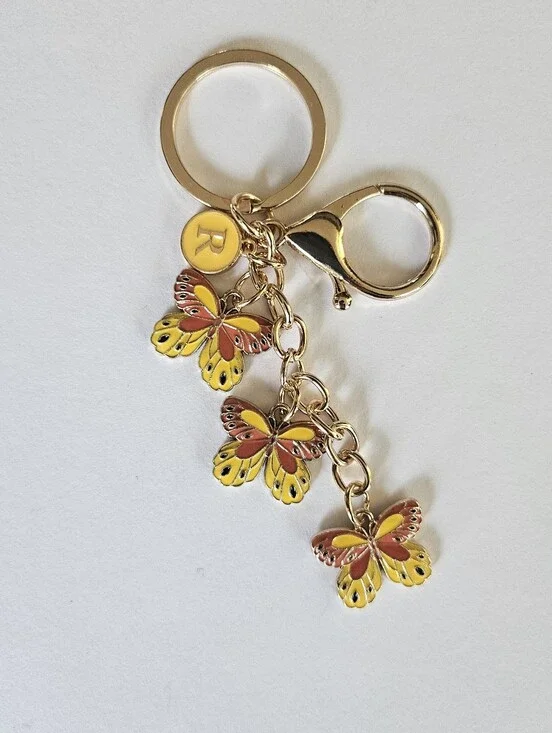 Yellow butterfly keyring, keychain. Bag charm. Has an R charm but can be removed