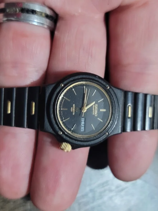 Seiko Black and Gold Analog Watch with Day Display