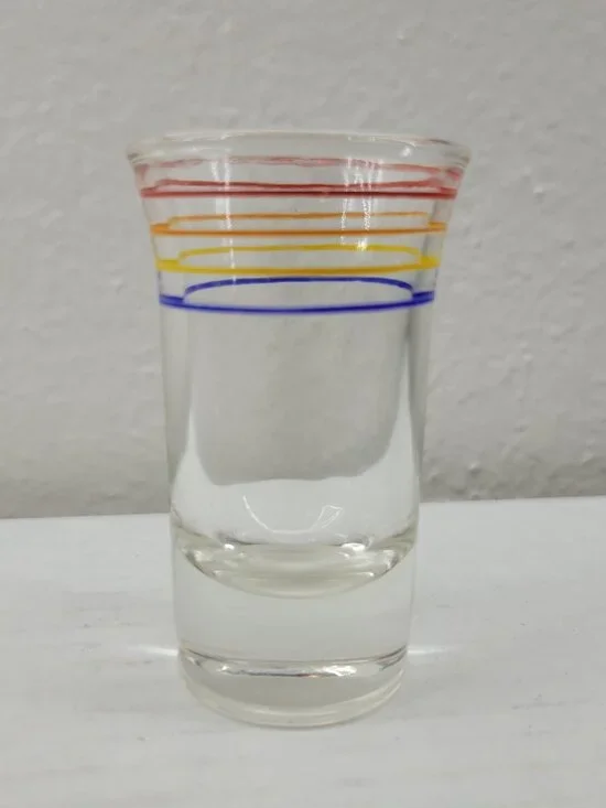 Vintage shot glass clear with orange red yellow blue stripes Mid-century Modern