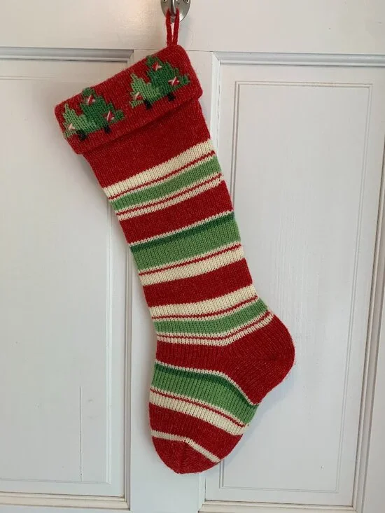 Vintage style knit Christmas stocking in red green and ivory stripe pattern