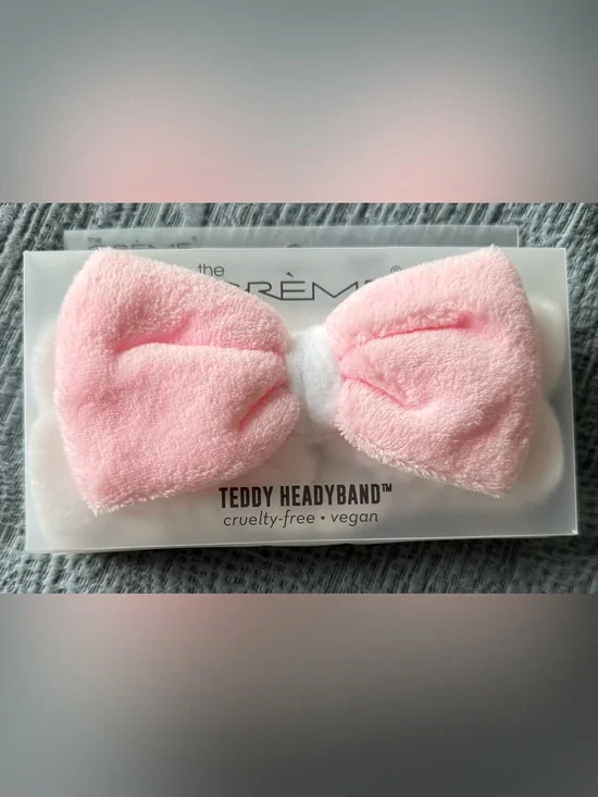 The Crème Shop Teddy Headband in Light Pink and White with a Soft Plush Bow