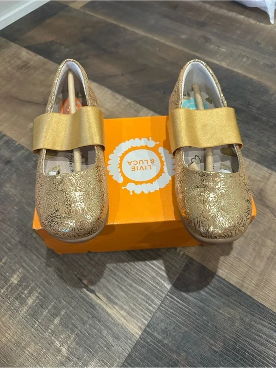 Livie & Luca Girls' Metallic Gold Embossed Mary Janes with Bow Strap