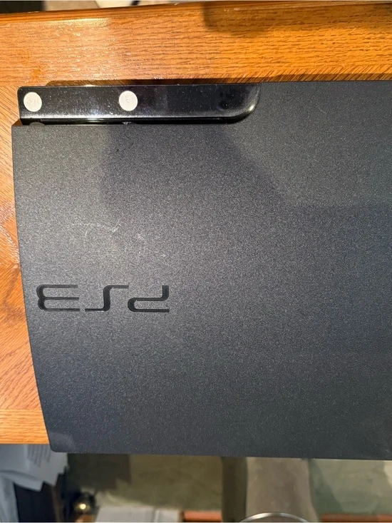 Sony PS3 Slim Matte Black Gaming Console Top View with games