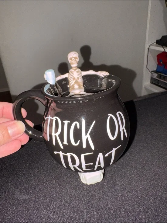 Scentsy mini warmer. Trick or treat with a skeleton sitting in the warmer top