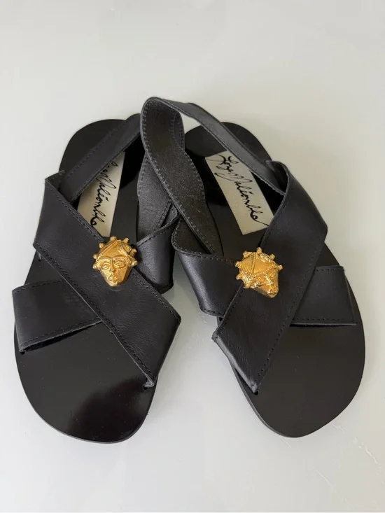 Black Leather Cross-Strap Sandals with Gold Medallion Accent