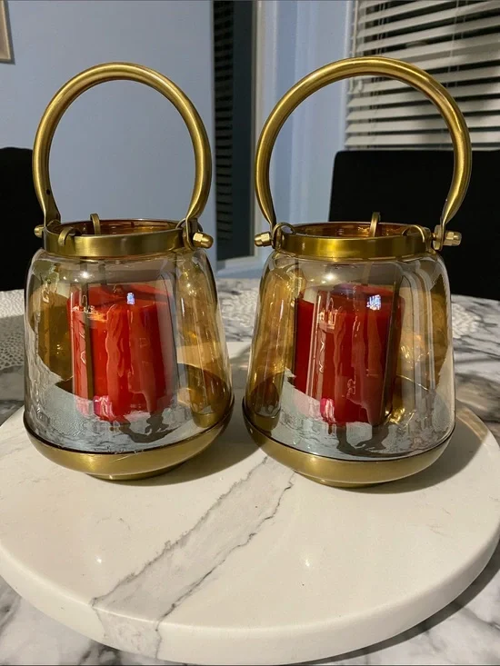 gold-tone glass and metal hurricane candle lanterns