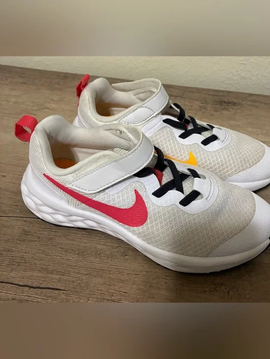 Girls Nike Kids White Sneakers with Pink Swoosh and Yellow Accent