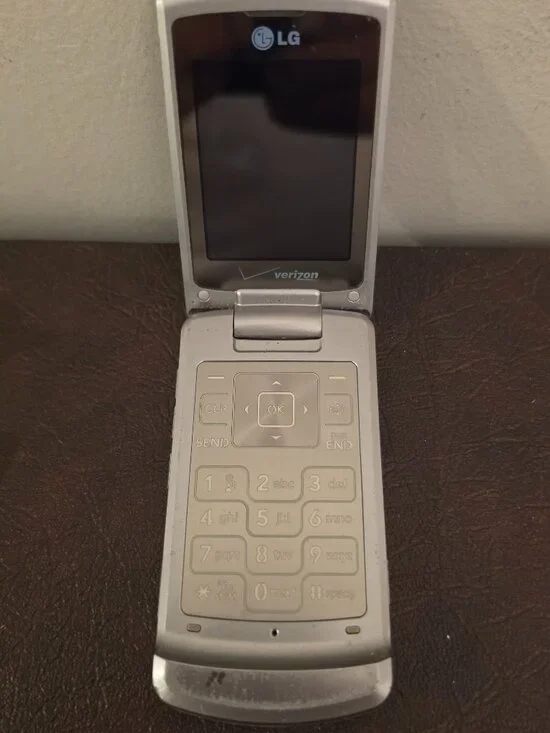 Vintage LG LX8700 S/LVE Flip cell phone with a Verizon logo from 2007.