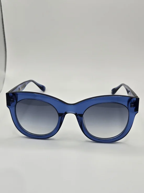 Aperçu sunglasses featuring a bold acetate frame and gold tone branding