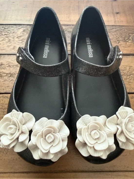 Mini Melissa Black Glitter Mary Janes with Cream Flower Appliqués