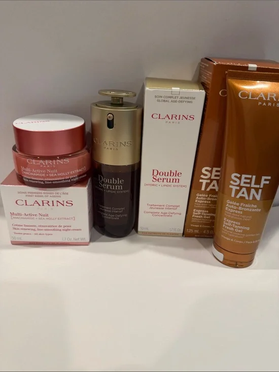 Clarins skincare set in pink, gold, white, and bronze