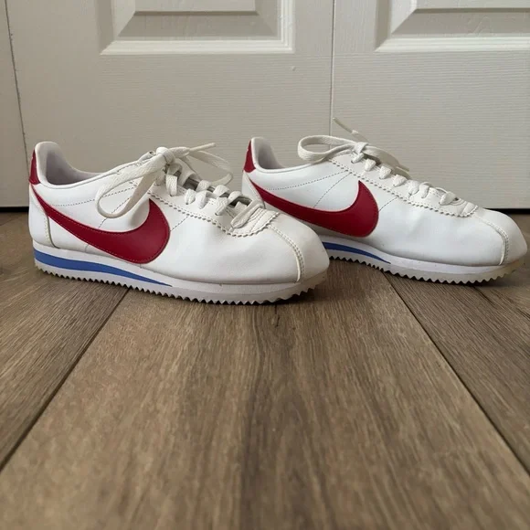 Nike Women's White Sneakers with Red Swoosh and Blue Accent