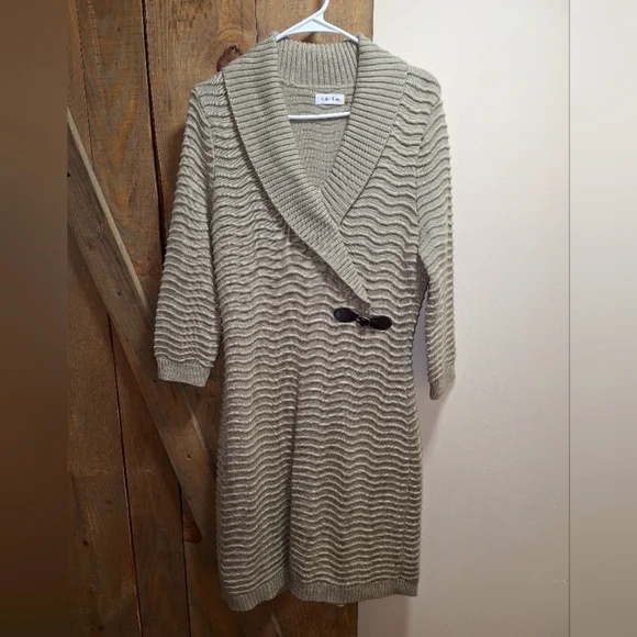 A Calvin Klein faux wrap ribbed knitted sweater dress in a ladies size medium.